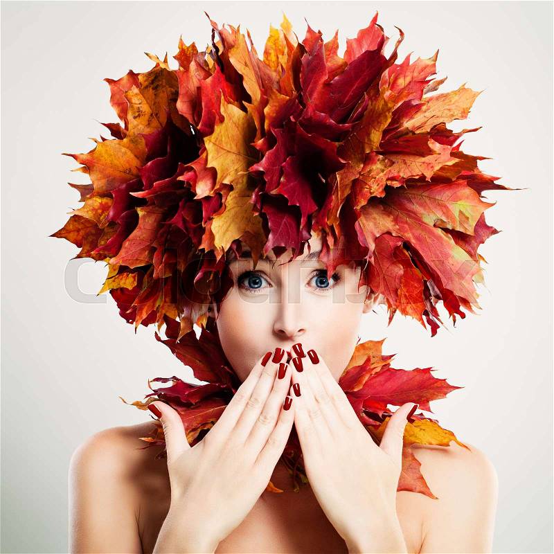 Surprised Woman with Autumn Leaves. Surprise and Fun, stock photo