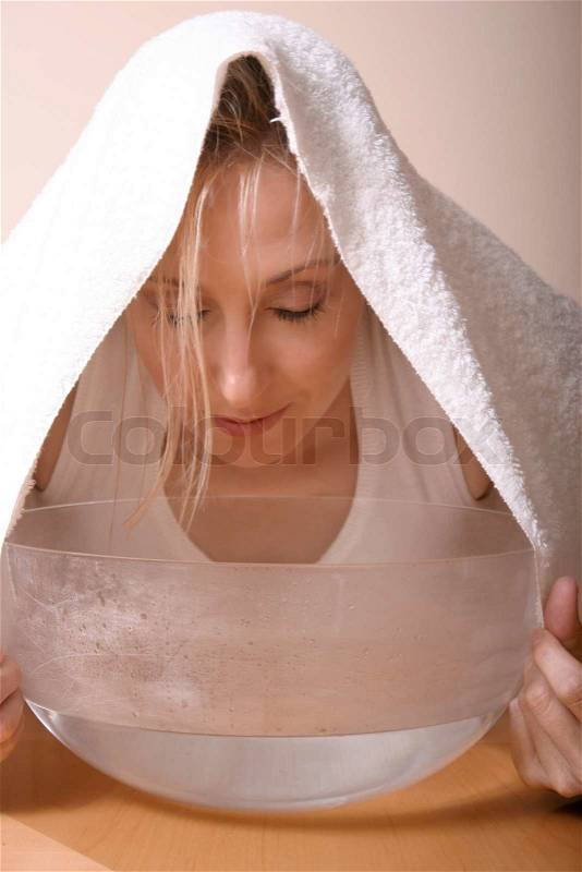 Hydrating herbal steam facial or a sick congested woman, stock photo