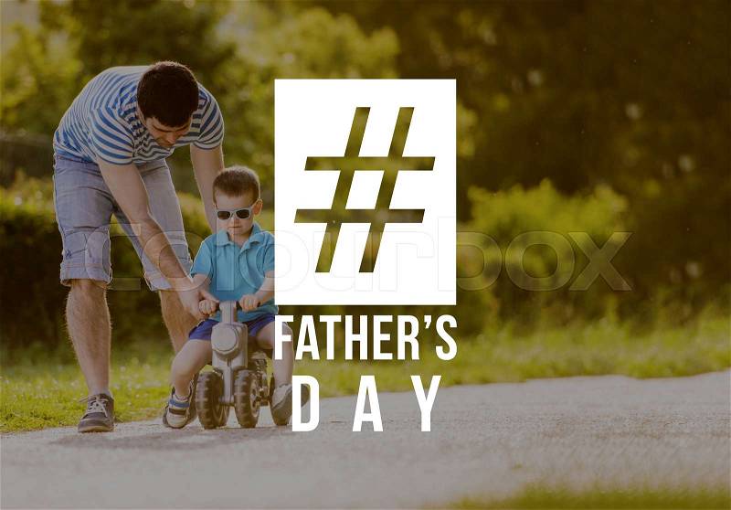 Young father and son riding bike outdoors. Fathers day concept, stock photo