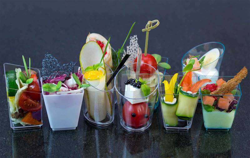 Molecular cuisine dishes in plastic buffet tableware, stock photo