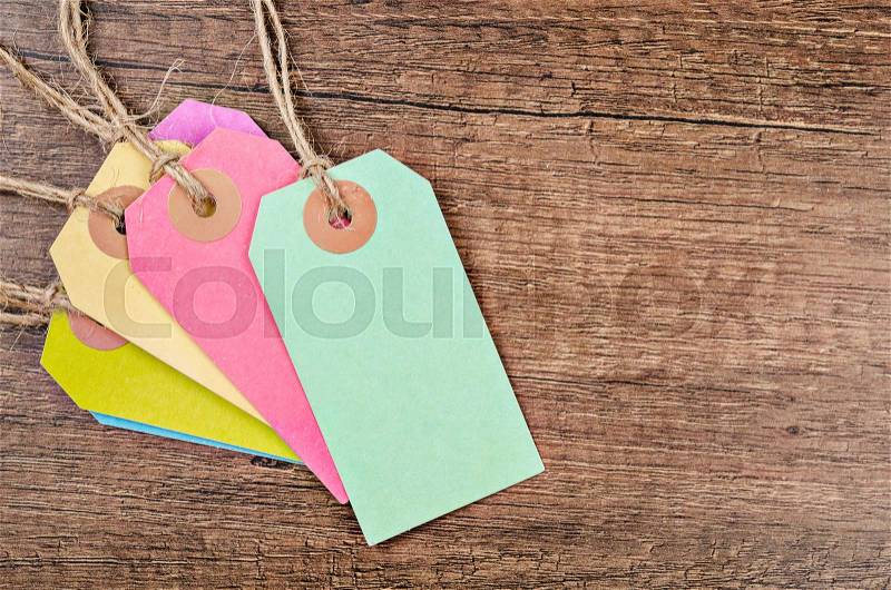 Colorful of price tag or labels on the wooden background, stock photo