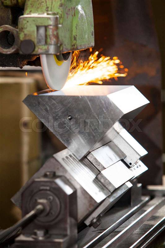 Metalworking industry. finishing metal surface on horizontal grinder machine, stock photo