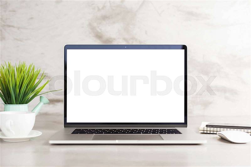 Laptop computer white blank screen on work table front view, stock photo