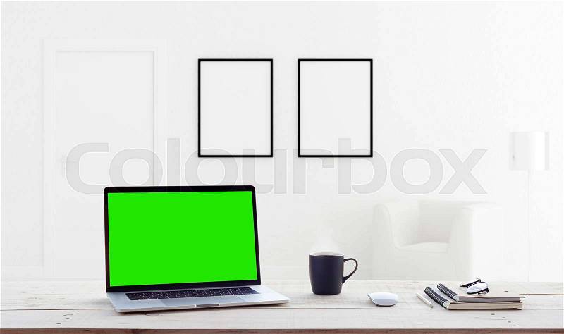 Laptop computer showing green screen in home interior background, stock photo