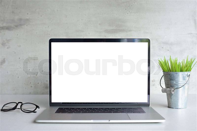 Modern laptop computer white screen on desk table front view, stock photo