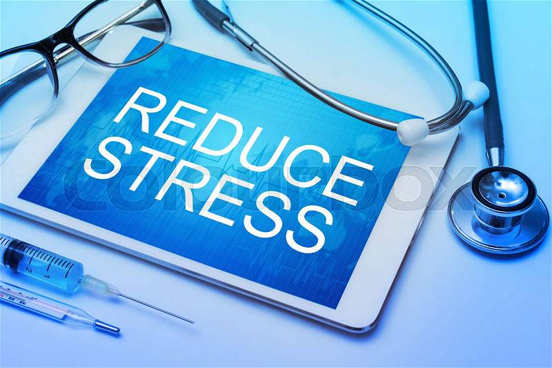 Reduce Stress word on tablet screen with medical equipment on background, stock photo
