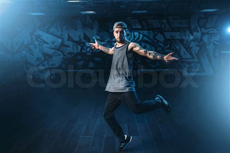 Male rapper in dance studio, trendy lifestyle. Modern urban dancing style, stock photo