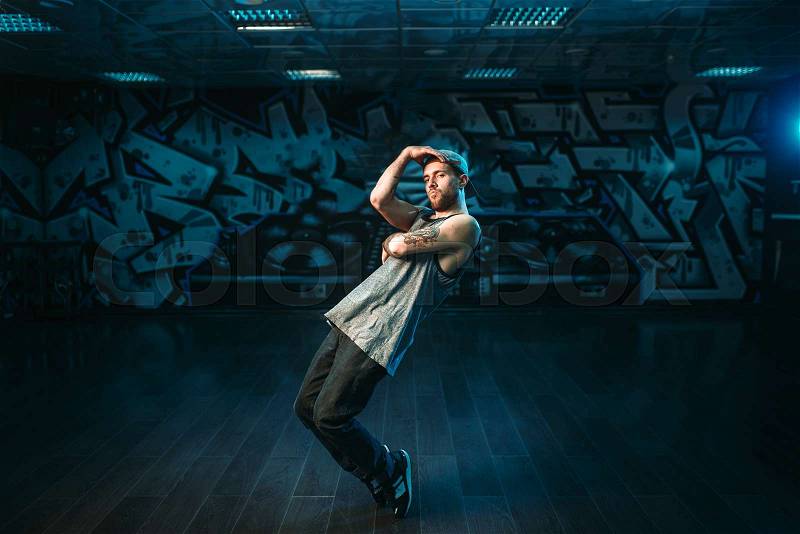 Male rapper in dance studio, rap performer. Modern urban dancing style, stock photo