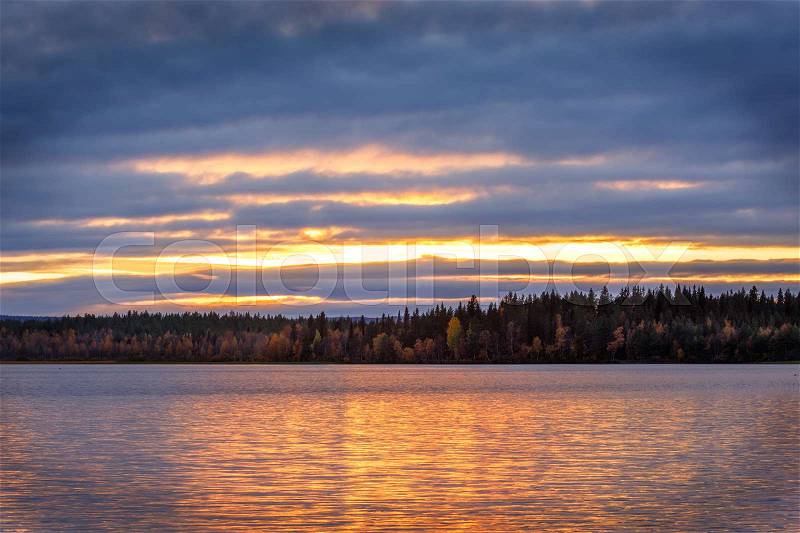 Beautiful autumn sunset on the lake, Finland, Lapland, stock photo