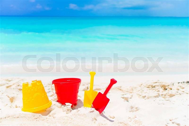 Kid\'s beach toys on white sandy beach background the sea, stock photo