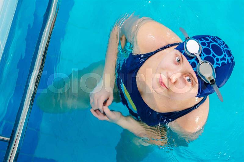 Young Caucasian Girl in the Swimming Pool. Top View Closeup. Children Recreation, stock photo