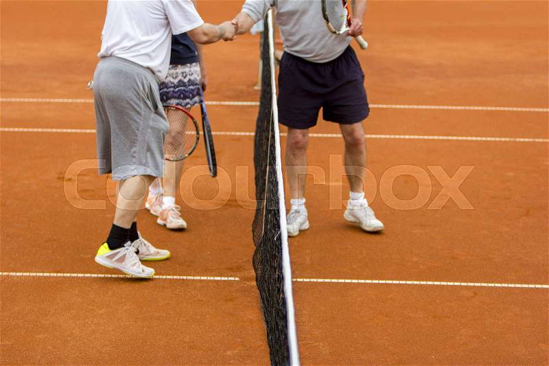 Tennis players shake hands after the tennis match, stock photo