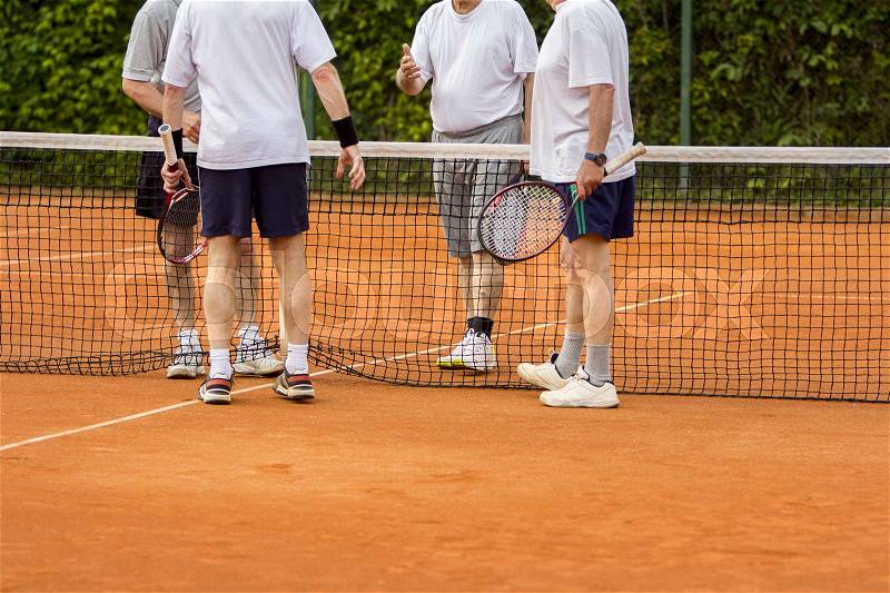 Tennis players shake hands after the tennis match , stock photo