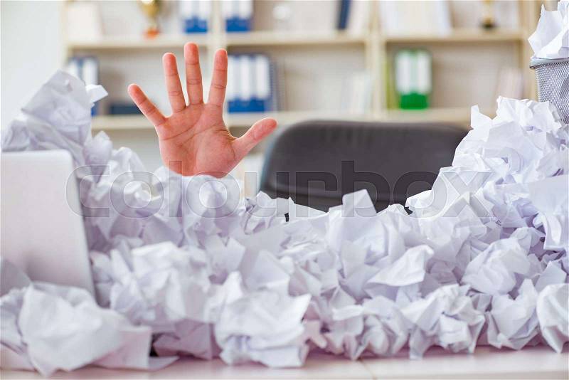 Businessman in paper recycling concept in office, stock photo
