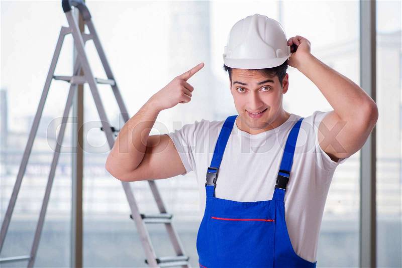 Young worker with safety helmet hardhat, stock photo