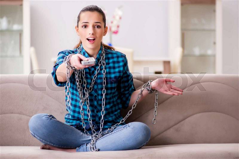 Young girl addicted to tv wasting her time, stock photo
