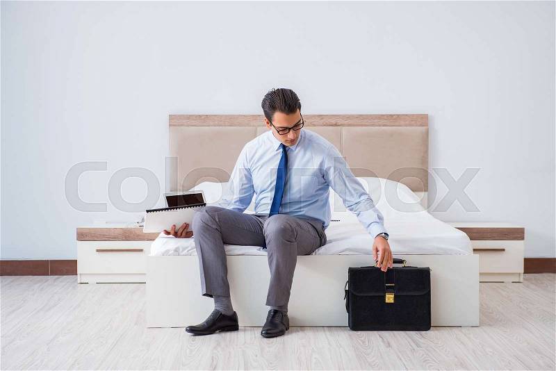 Businessman in the hotel room during travel, stock photo