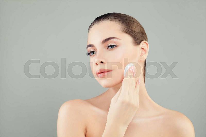 Skin Care and Facial Treatment Concept. Young Healthy Woman with Beautiful Clear Skin Holding Cotton Pads on Banner Background with Copy Space, stock photo