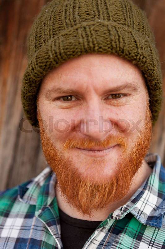 Portrait of a red haired hipster guy putting silly face , stock photo