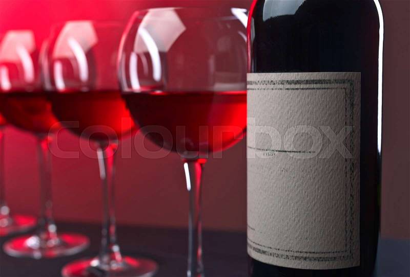 Bottle and glasses of red wine . Old paper label , stock photo