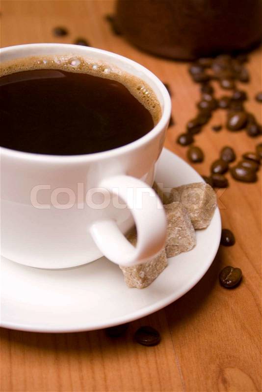 Cup of coffee, sugar and beans on wooden table, stock photo