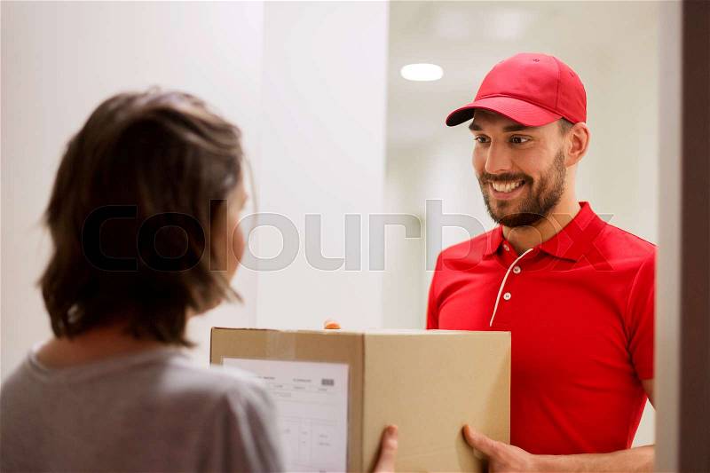 Delivery, mail, people and shipping concept - happy man delivering parcel box to customer home, stock photo