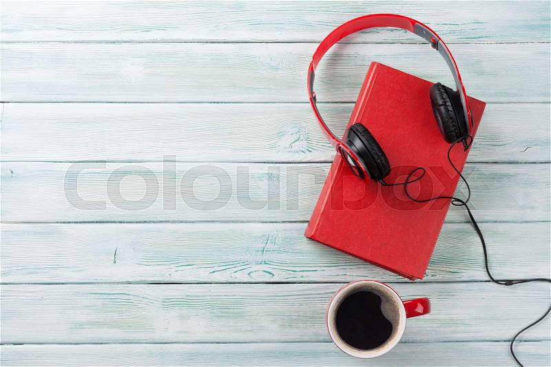 Audio book concept. Headphones, coffee and book over wooden table. Top view with space for your text, stock photo