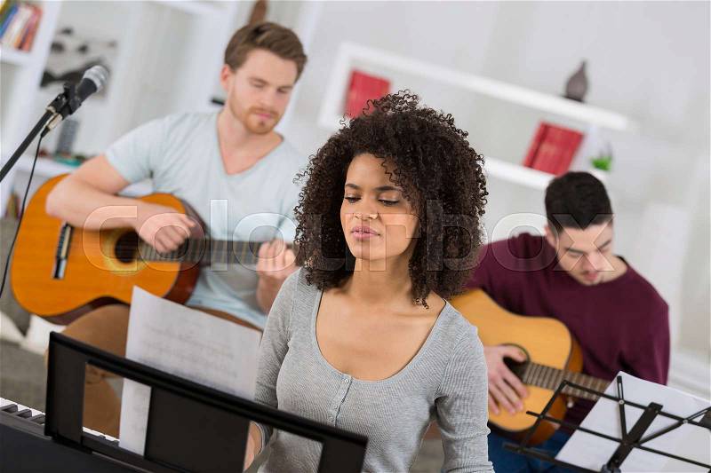 Young musicians rehearsing, stock photo