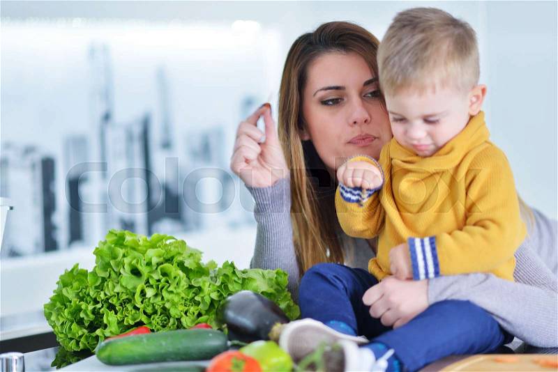 Mother and child preparing lunch from fresh veggies, stock photo