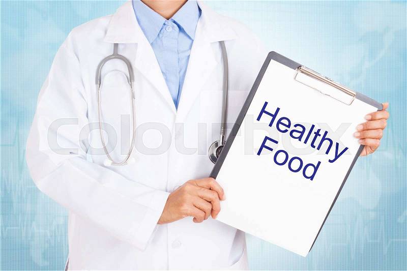 Doctor holding clipboard with healthy food text on a sheet of paper. on white background, stock photo