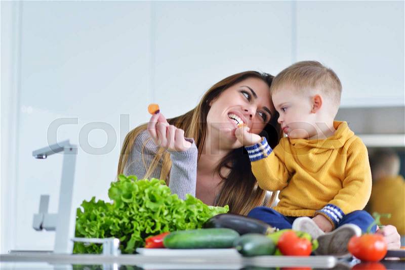 Mother and child preparing lunch from fresh veggies, stock photo