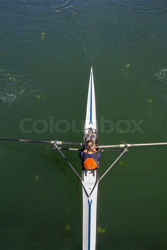 Young woman rowing in boat on the lake , stock photo
