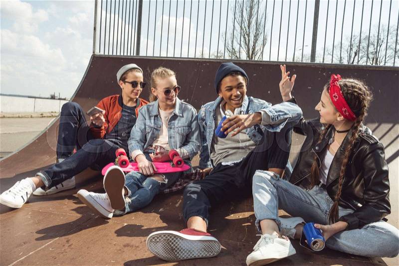 Teenagers having fun in skateboard park with penny board, hipster students concept , stock photo
