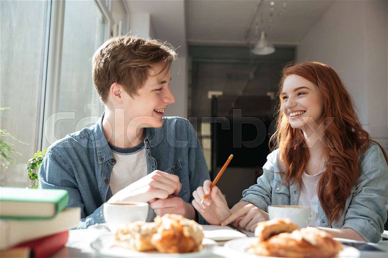 Shot of conversation of two pretty young students in cafe, stock photo