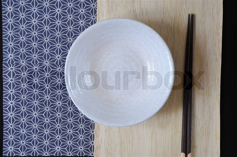 Above of empty dish with chopstick on wooden board in Japanese style, stock photo