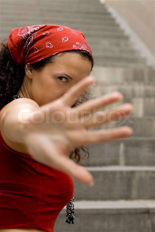 Woman in red hides her face by hand, stock photo
