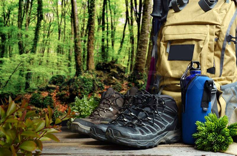 Backpack hiking with boots of mountain and water bottle, stock photo