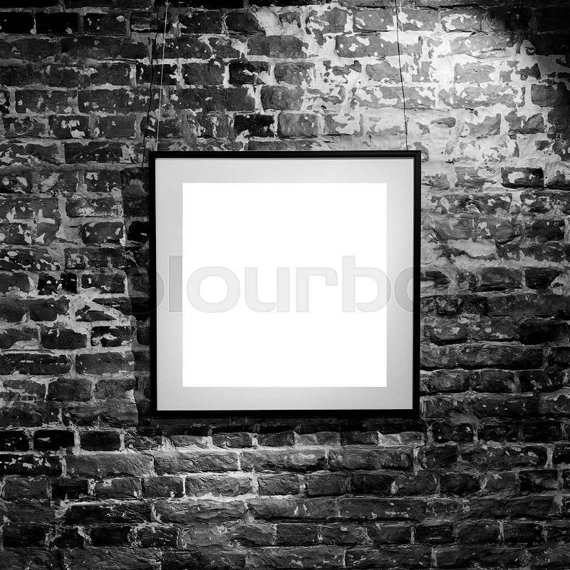 Empty square frame on black brick wall. Blank space poster or art frame waiting to be filled. Square Black Frame Mock-Up, stock photo