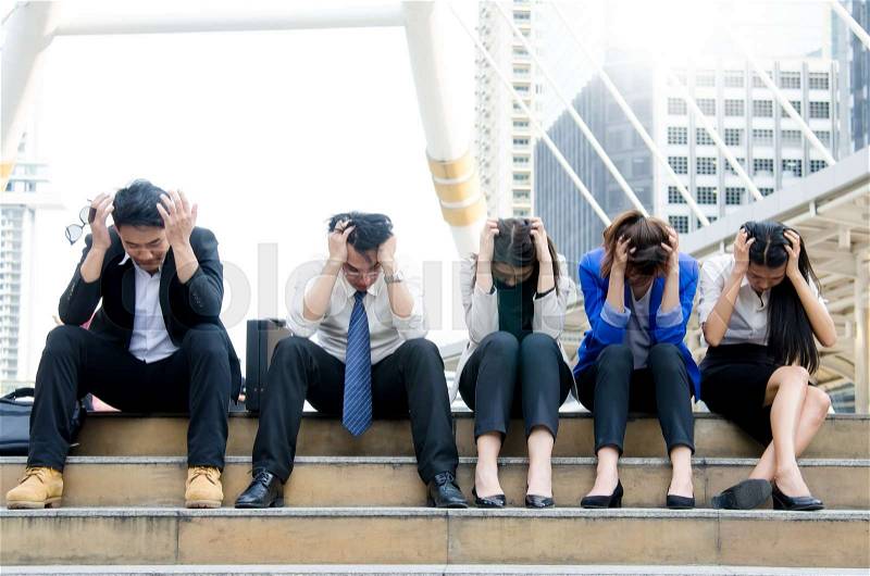 Group of asian business people worried and concerned at walk way area in the city. Business concepts, stock photo