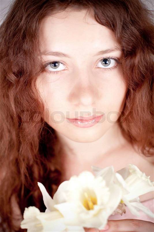 Closeup portrait of beautiful woman with narcissus, stock photo
