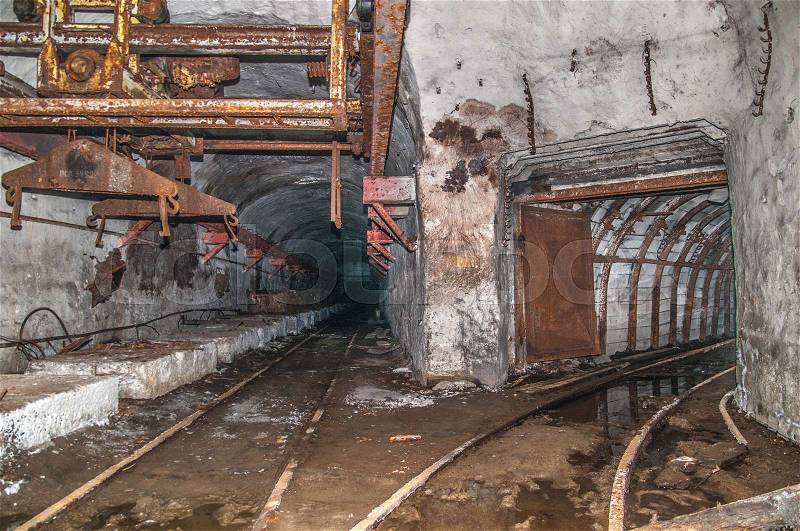 Trolley in the mine tunnel with rails, stock photo