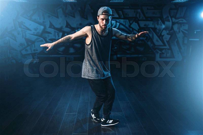 Male rapper in dance studio, trendy lifestyle. Modern urban dancing style, stock photo