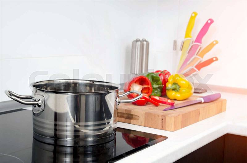 Pot and vegetables in modern kitchen with induction stove. stove cooker hob kitchen pot pan steel gourmet concept, stock photo