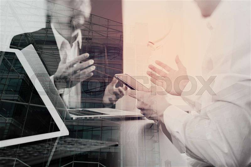 Co working team meeting concept,businessman using smart phone and digital tablet and laptop computer in modern office with London city exposure , stock photo