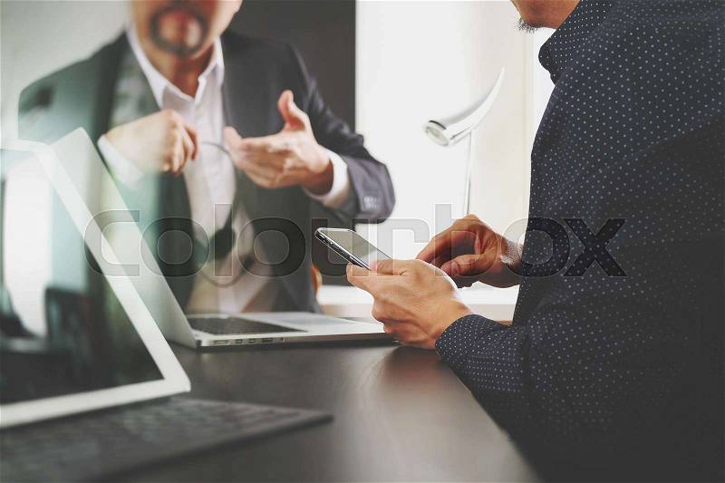 Co working team meeting concept,businessman using smart phone and digital tablet and laptop computer in modern office, stock photo