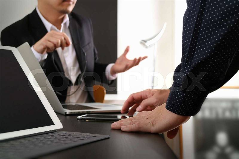 Co working team meeting concept,businessman using smart phone and digital tablet and laptop computer in modern office, stock photo