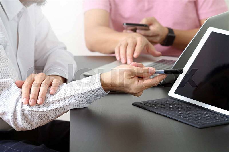 Co working team meeting concept,businessman using smart phone and digital tablet and laptop computer in modern office , stock photo