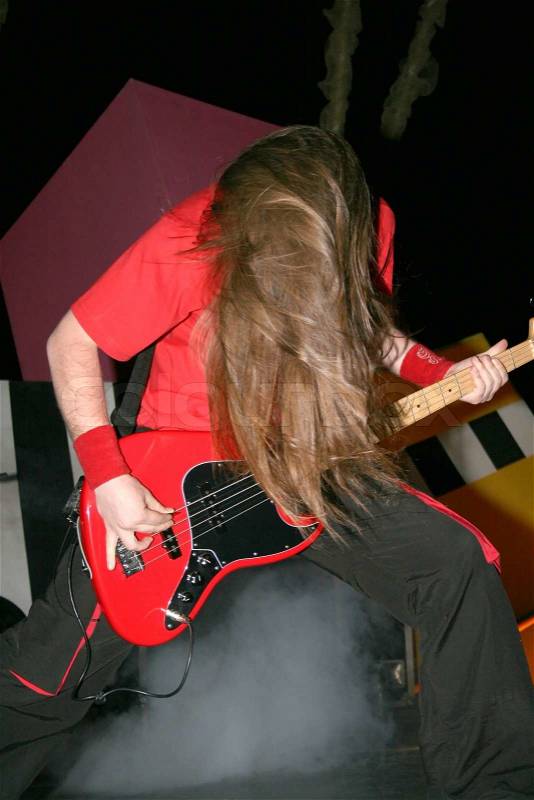 Headbanging rock guitarist in rock concert, stock photo
