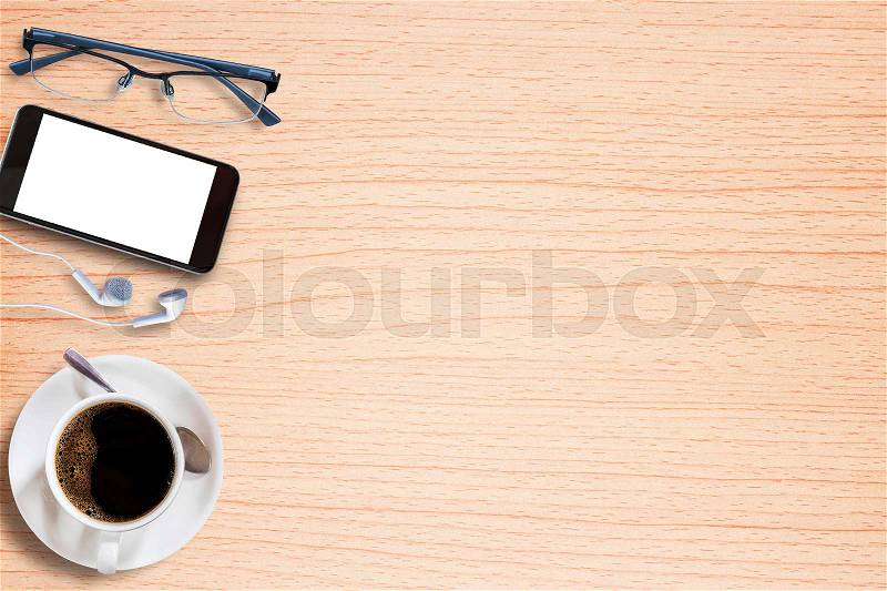 Smart phone,glasses and earphone with cup of coffee on old wooden background with copy space. top view, stock photo