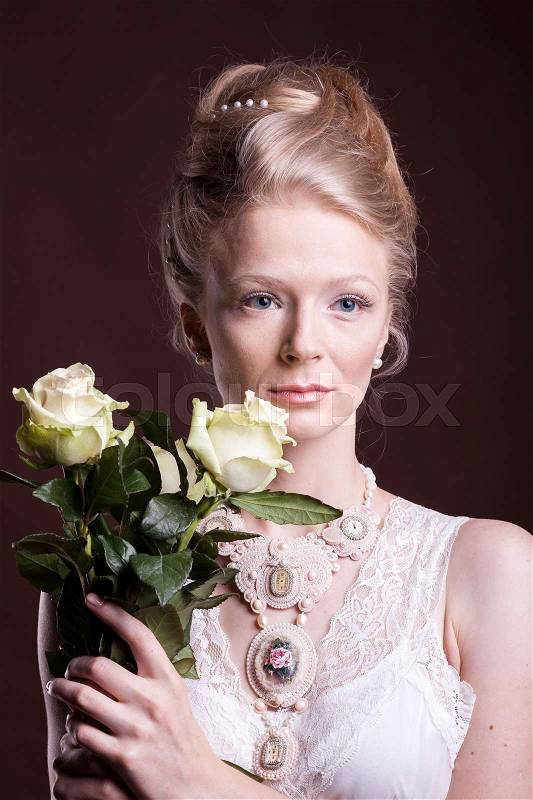 Blonde woman in victorian dress with roses in hands. Rich and vintage. Luxury and elegance. Studio photo, stock photo